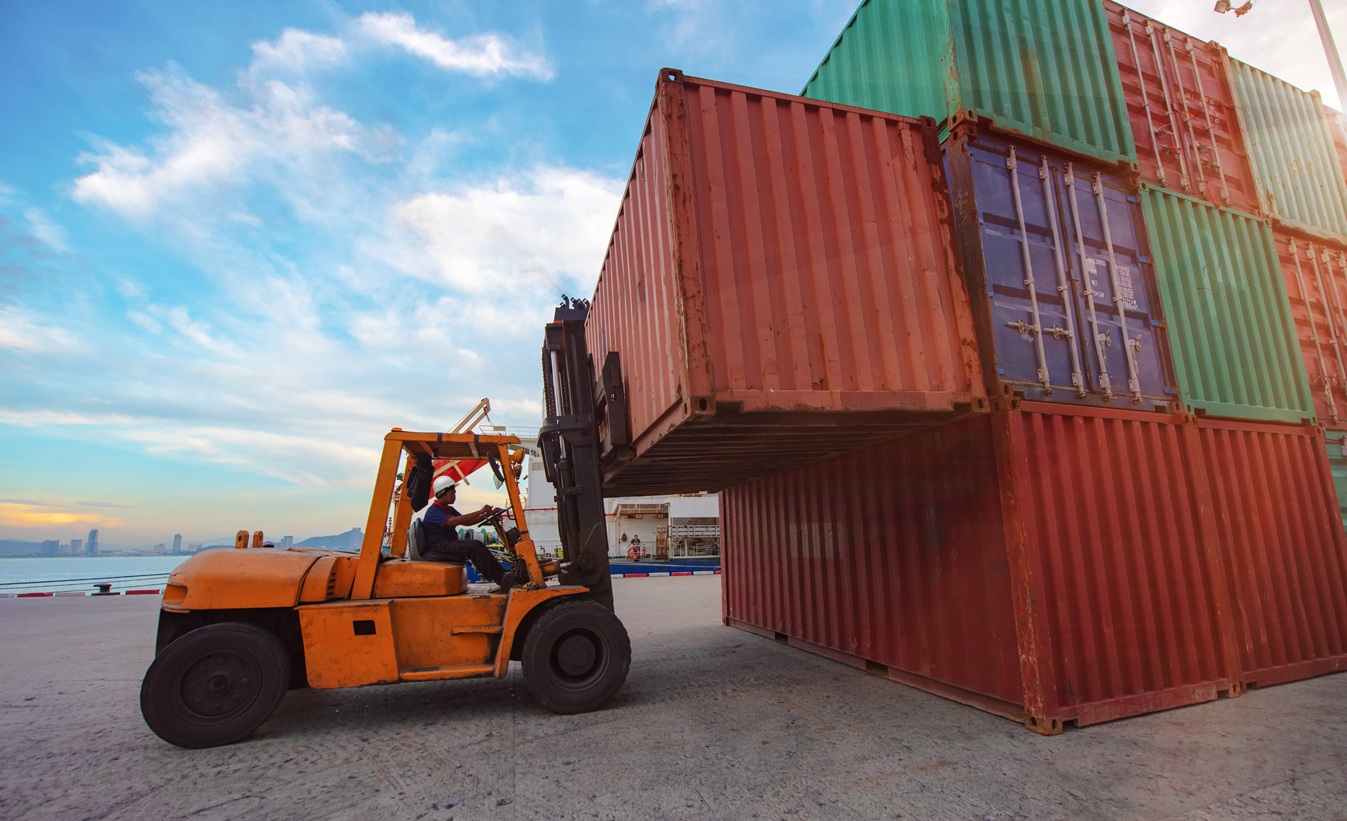 Container unit handling by forklift to transfer